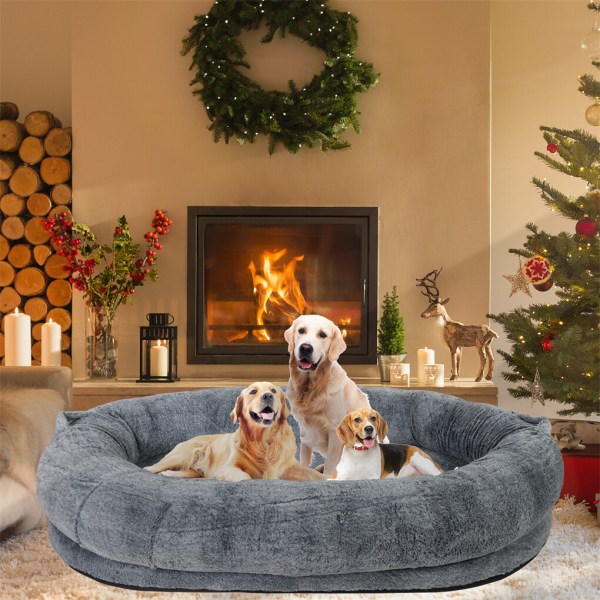 Three dogs in cosy bed by fireplace