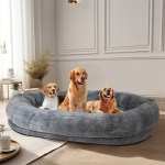 Three dogs sitting in large grey pet bed