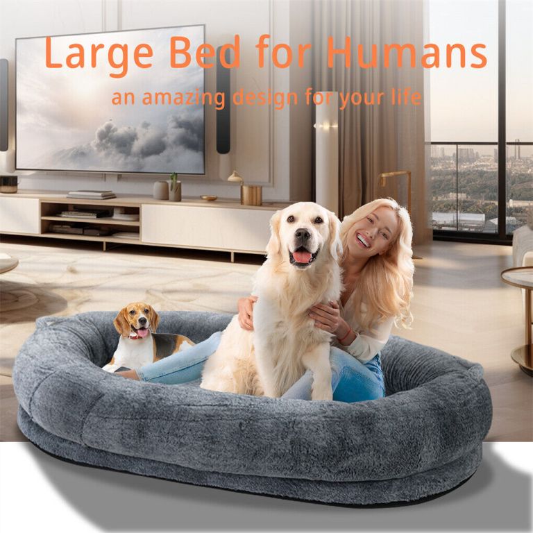 Woman and dogs in oversized plush bed