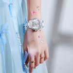 women's butterfly quartz watch with ceramic steel strap and luminous hands (silver shell white surface steel belt) Silver butterfly watch on wrist with blue dress