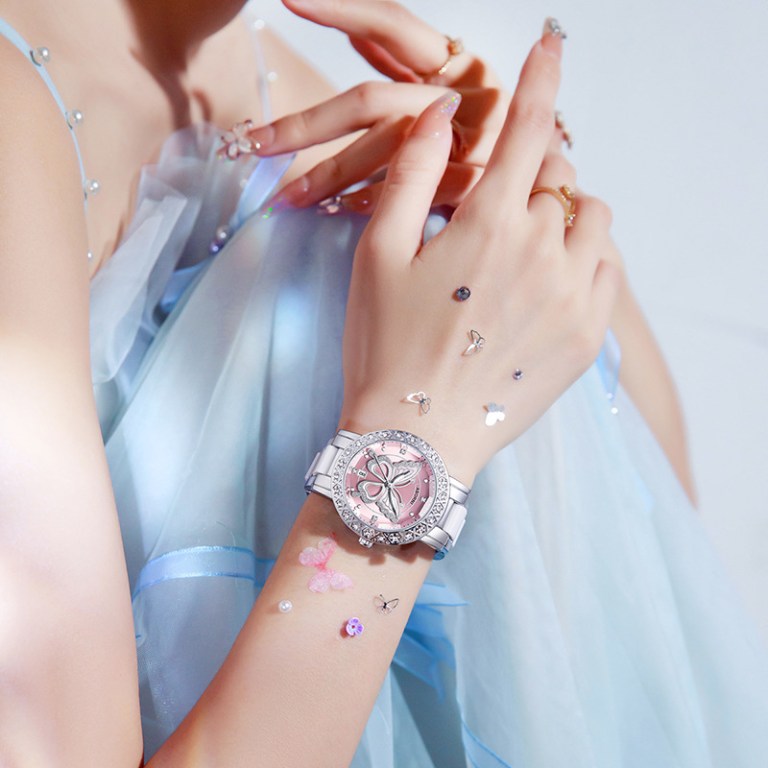 Woman wearing butterfly watch and blue dress