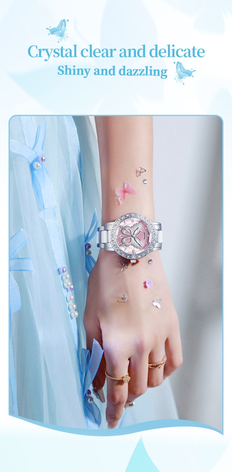 Butterfly-themed pink watch on wrist with blue dress