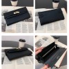 Black leather clutch wallet on open book