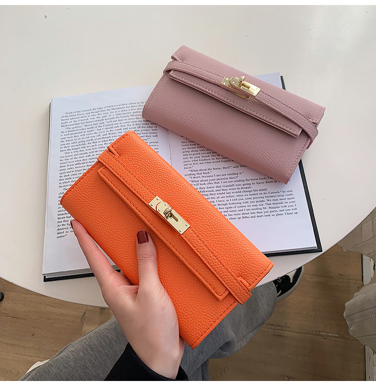 black elegant women's turn lock long wallet black pu leather clutch purse with card slots & zipper pocket Orange and pink wallets on open book