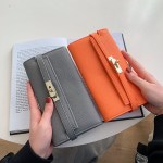 black elegant women's turn lock long wallet black pu leather clutch purse with card slots & zipper pocket Grey and orange wallets held over open book