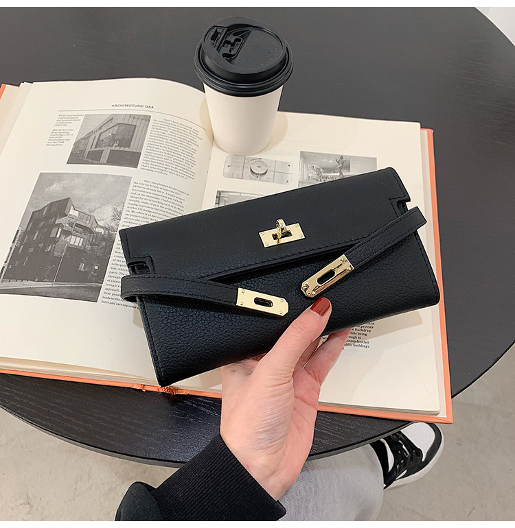 black elegant women's turn lock long wallet black pu leather clutch purse with card slots & zipper pocket Black leather clutch over open book and coffee