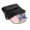 Black leather handbag with everyday essentials inside