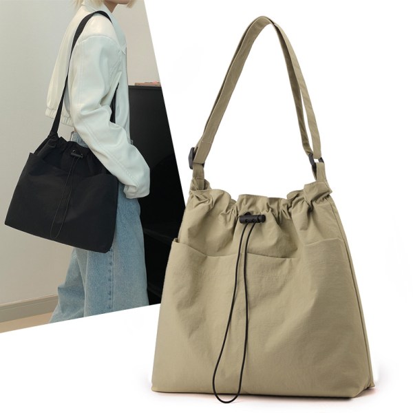 Beige drawstring shoulder bag with adjustable strap