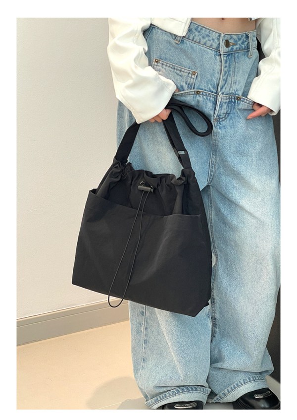 Black tote bag with light blue jeans outfit