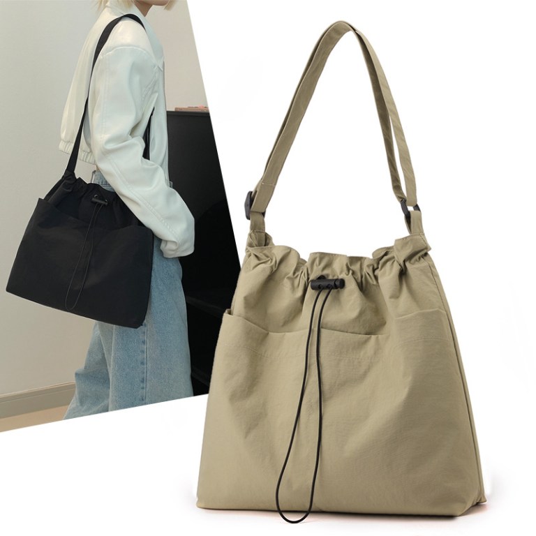 Beige drawstring shoulder bag with adjustable strap
