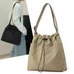 Beige drawstring shoulder bag with wide strap