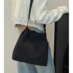 Black shoulder bag with white cropped jacket