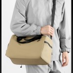 large capacity travel duffel bag with shoe compartment & wet pocket multi purpose gym & weekend bag(pink) Person wearing grey jacket carrying beige duffel bag