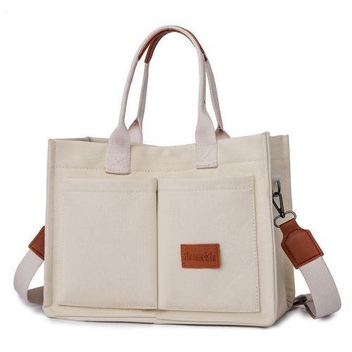 v888 elosung48944 00.jpg Cream canvas tote bag with leather accents
