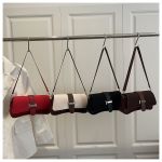 Four small shoulder handbags hanging on rack