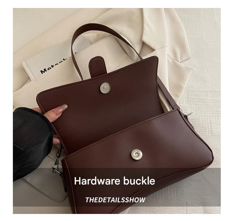 Brown leather handbag with silver hardware buckle