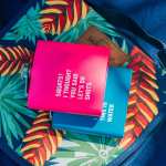 Two colourful flasks on tropical patterned bag