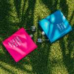 Colourful hip flasks on green grass