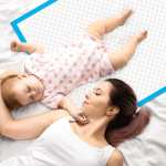 160pk adult disposable bed underpads 60 x 90cm Mother lying beside sleeping baby on bed