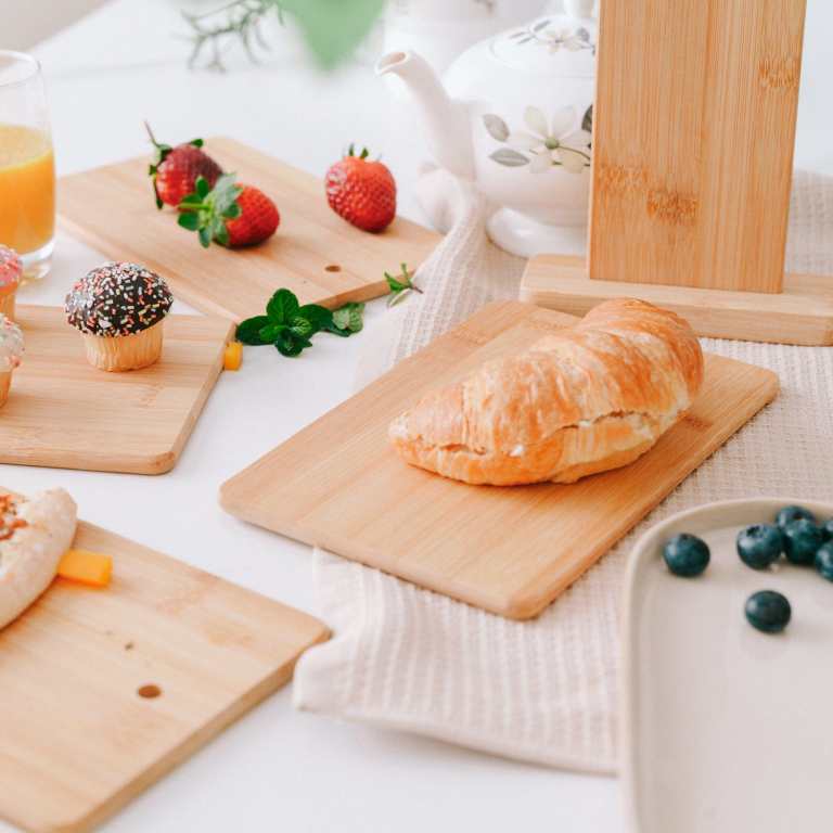 Breakfast spread with bread roll, fruit and cupcakes