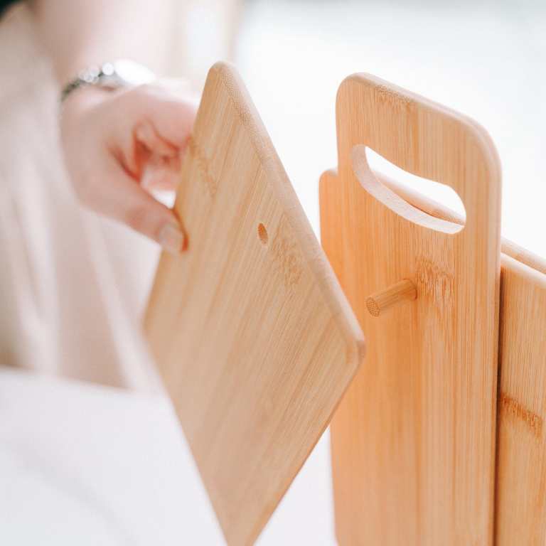 Bamboo chopping boards on wooden storage stand