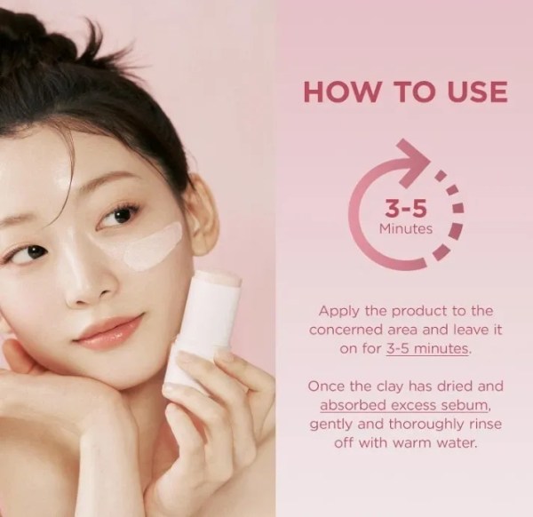 Woman applying clay mask holding skincare bottle