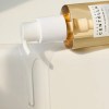 Cleansing oil bottle with pump dispensing liquid