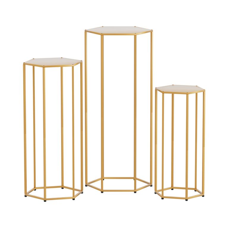 Three gold hexagonal pedestal stands with glass tops