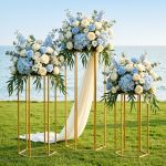 Coastal wedding floral arrangements on gold stands