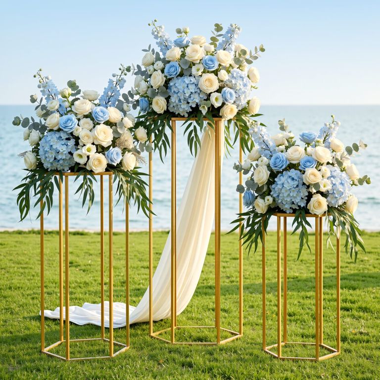 Coastal wedding floral arrangements on gold stands