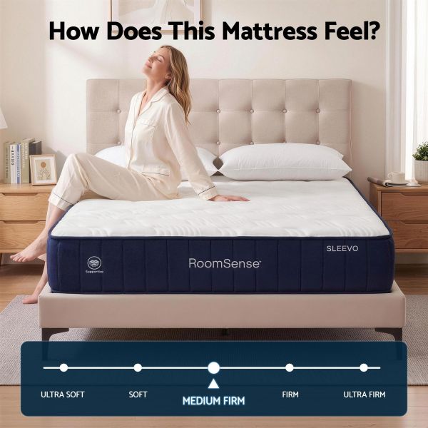 Woman sitting on medium-firm mattress in bedroom