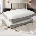 Two contoured white pillows on modern bed